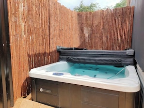 Relax in our spa. Accessible through a gate in your deck and shared between two other units.