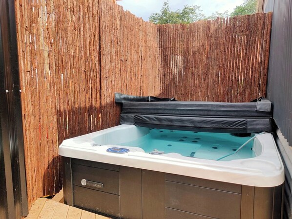 Relax in our spa, currently shared between two units and accessible through a locked gate.