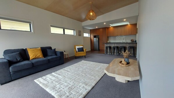Living room with view to breakfast bar / kitchen. Couch folds out if needed.