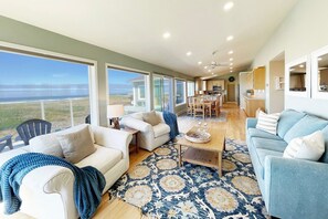 The living, dining and kitchen are open to sweeping ocean views