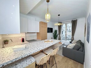 Large counter having a view of the kitchen and living room