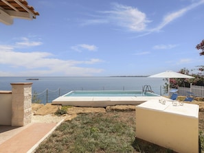 Cloud, Sky, Water, Azure, Swimming Pool, Seaside Resort, Shade, Outdoor Furniture, Building, Coastal And Oceanic Landforms