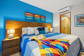 There are bedside tables and lamps