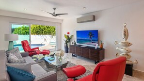 The sitting area features a cozy sofa and a pair of ultra-comfy chairs, perfect for enjoying movie time on the Apple TV