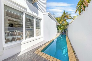 The pool area on the side of the home.