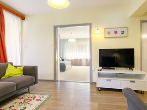 Furniture, Couch, Building, Interior Design, Comfort, Orange, Wood, Television, Living Room, Floor