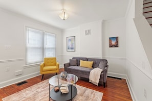 Cozy and welcoming living area with ample seating and a warm, homey atmosphere.