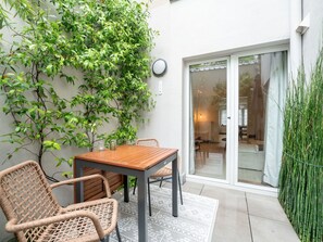 Plant, Furniture, Property, Table, Outdoor Furniture, Interior Design, Building, Wood, Door, Grass