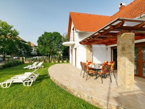 Sky, Plant, Window, Building, Outdoor Furniture, Shade, Land Lot, Table, Chair, Natural Landscape
