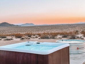 Hot tub and cowboy tub soaking pool positioned to take in the sweeping views