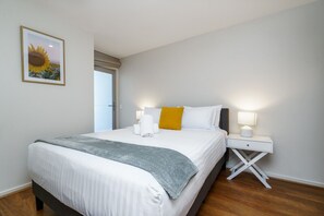 Rest comfortably on a queen-size bed with professionally laundered linen, offering a fresh and luxurious sleeping experience.