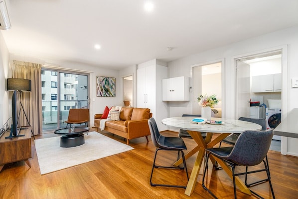 Enjoy the modern dining and living room, complete with a stylish leather lounge that adds a touch of sophistication and comfort to the space.
