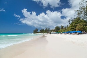 Beach nearby, white sand, sun loungers
