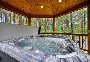 Soak your cares away in the hot tub while enjoying the serene views of the surrounding forest.