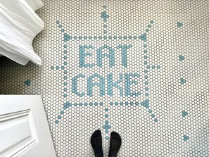 The house has character, including a mosaic: "Enjoy life, eat the cake!