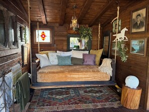 Swing into a covered porch with a Bali bed, perfect for stargazing and relaxing!
