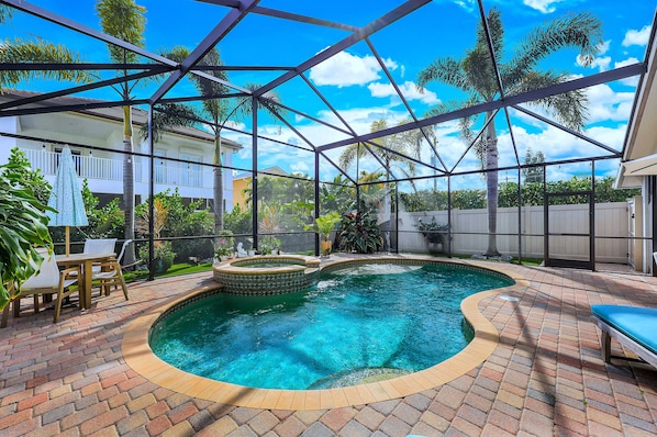 Pool with a lanai screen enclosure.