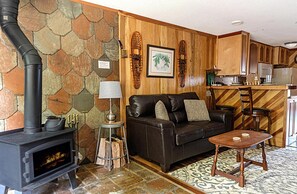 The warmth of a fire in the wood stove and the crackling of wood logs makes the living space feel instantly cozy and welcoming.