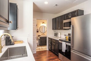 Full kitchen features a coffee maker, basic cooking essentials
