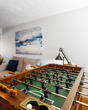 Secondary Living Area featuring a Foosball Table, Smart TV, and Designer Furnishings.