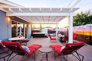 Private backyard patio with a new mural, outdoor dining area, ample seating, hot tub, above-ground pool, lounge chairs, fire pit, BBQ grill, ping pong table, and horseshoe.