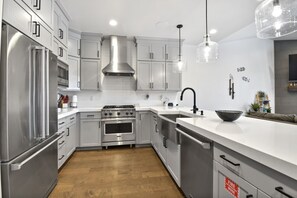 Open-concept modern kitchen, offering a great space to prepare meals while staying connected with the group.