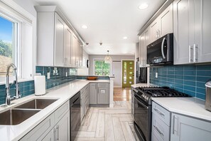 Modern kitchen with stainless steel appliances, ready for your culinary creations.