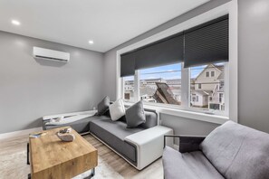 The living room is kept plenty comfortable anytime of year with a mini split. Mini splits can be found in every room and provide heat and AC.