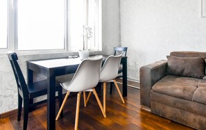 Cozy dining space with natural light—perfect for meals or working remotely. Book now!