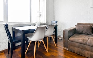 Cozy dining space with natural light—perfect for meals or working remotely. Book now!