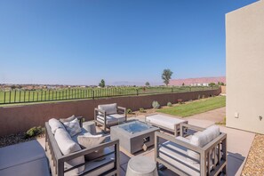 Outdoor Fire Pit and Seating - Stay warm next to the fire-pit and relax while looking out over the golf course.