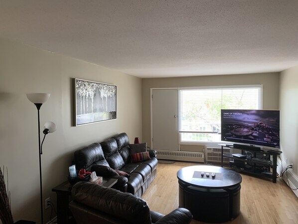 TV Room. Reclining couch and lazy boy chair. Round table can be raised or lowered using center steel button. Perfect for snacks and treats while watching a movie.