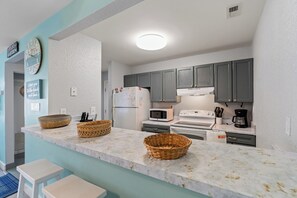 The kitchen counter provides additional  space for serving snacks or meals.