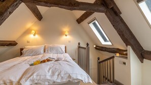 Sleep below the original wooden eaves
