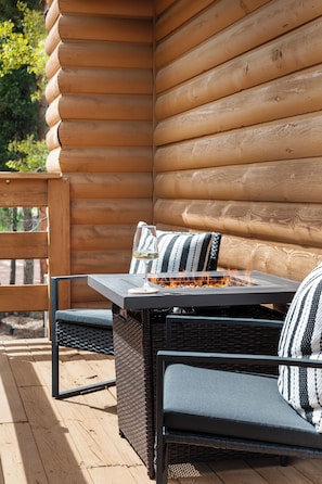 Cozy fire pit and seating on the patio that overlooks the towering trees!