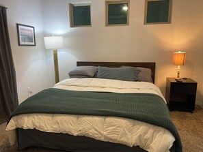 Master bedroom  with a king purple mattress bed 