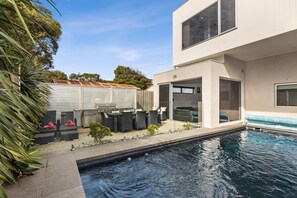 A private solar-heated pool with surrounding sun loungers for ultimate relaxation