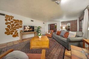 Stylish living room with cozy seating, smart TV, and fireplace (nonfunctional)