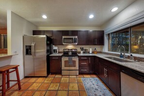 Well-equipped and fully stocked kitchen with stainless steel appliances