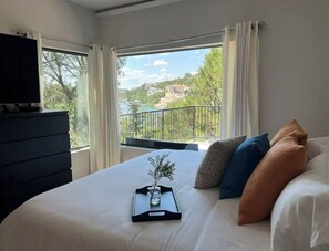 Bedroom 1. This space no longer has curtains. It has the most beautiful view!