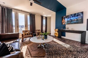 Open concept living area with comfortable seating and TV