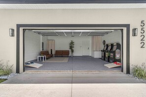 Hangout in the cozy garage turned game room! Retro arcade games. Cornhole.