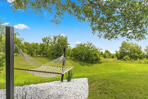 Relax in the hammock and enjoy the peaceful backyard.