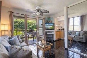 Keep comfortable in the living area featuring Cable TV, ceiling fan, & window AC.