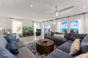 Spacious coastal-chic living room with tons of light and beach views
