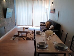Gather in our elegant dining room, designed for comfort and style. It features a spacious dining table, perfect for enjoying meals with family and friends, and creating memorable dining experiences during your stay.