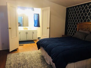 King size bed, with attached bathroom, shower, and a large tub.  