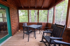 This screen-n, covered deck is a great spot to relax and get fresh air.