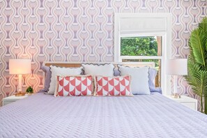 Relax and unwind in our serene downstairs master suite, where vibrant colors meet cozy comfort. Perfect for a restful night, this peaceful retreat offers a refreshing blend of style and relaxation.
