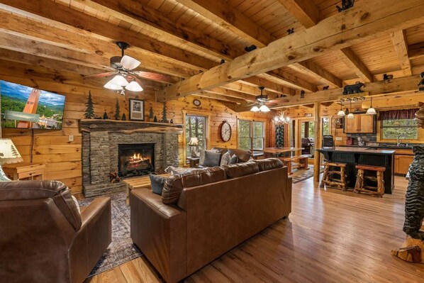 Living area with leather seating, gas fireplace, and Smart TV